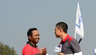 Jazz Janewattananond of Thailand (R) celebrates with Siddikur Rahman (L) of Bangladesh after winning the final round of the Bangladesh Open golf tournament at the Kurmitola Golf Club in Dhaka on February 4, 2017. / AFP / STR
