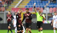 AC Milan Argentinian midfielder Jose Ernesto Sosa (C) receives a yellow card during the Italian Serie A football match AC Milan vs Sampdoria at 