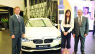 Todd Creege, President ConocoPhillips (left), and Ihab Allam, General Manager of BMW (right) with Rona Salazar the winner of #MakeItClickQatar at BMW showroom West Bay. Pic: Abdul Basit / The Peninsula