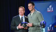 NFL Commissioner Roger Goodell (left) presents Tom Brady with the Pete Rozelle Trophy for Most Valuable Player in Houston on Monday.