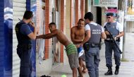 Police search and question men before allowing them to continue on their way in Cachoeira do Itapemirim, Espirito Santo, Brazil, February 7, 2017. REUTERS/Paulo Whitaker