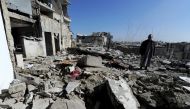 Eymad, 54, stands on the rubble of the damaged rooftop of his house at al-Mouassassi street in Aleppo, Syria, February 2, 2017. REUTERS/Omar Sanadiki
