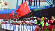 Chinese families along with Pakistan Navy's servicemen wave flags to welcome a Chinese naval vessel (unseen) upon its arrival to participate in Pakistan Navy’s Multinational Exercise AMAN-17, in Karachi, Pakistan, February 9, 2017. REUTERS/Akhtar Soomro