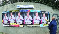 A man pastes electoral posters of French presidential election candidate Francois Fillon, on the streets of Marseille, yesterday.