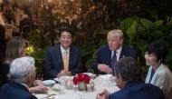 US President Donald Trump, Japanese Prime Minister Shinzo Abe (2nd-L), his wife Akie Abe (R), US First Lady Melania Trump (L) and Robert Kraft (2nd-L),owner of the New England Patriots, sit down for dinner at Trump's Mar-a-Lago resort on February 10, 2017