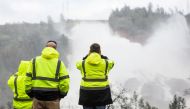 California Department of Water Resources personnel monitor water flowing through a damaged spillway on the Oroville Dam in Oroville, California, U.S., on February 10, 2017. (Reuters)