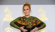 Adele holds the five Grammys she won including Record of the Year for 