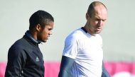 Bayern Munich's Brazilian midfielder Douglas Costa (L) and Bayern Munich's Dutch midfielder Arjen Robben (R) arrive for the final team training at the team training's area in Munich, southern Germany, on February 14, 2017, on the eve of the UEFA Champions