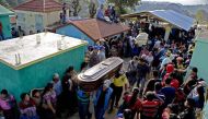 Thousands of indigenous Guatemalans accompany to the cemetery the coffins of two children killed by their kidnappers in the Cerro Alto village in San Juan Sacatepequez, 45km west of Guatemala city on February 14, 2017. AFP / JOHAN ORDONEZ
