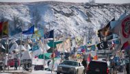 Flags flap in the wind on the main thoroughfare of Oceti Sakowin Camp on the edge of the Standing Rock Sioux Reservation on December 3, 2016 outside Cannon Ball, North Dakota (AFP Photo/JIM WATSON)
