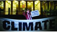 A man wearing a mask depicting US President Donald Trump protests during a demonstration 