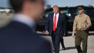 President Donald Trump walks to greet supporters after arriving on Air Force One at the Palm Beach International Airport to spend part of the weekend at Mar-a-Lago resort on February 17, 2017 in West Palm Beach, Florida. Joe Raedle/Getty Images/AFP
