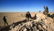 Fighters of the Hashed al-Shaabi (Popular Mobilisation) paramilitaries prepare defensive positions near the frontline village of Ayn al-Hisan, on the outskirts of Tal Afar west of Mosul, where Iraqi forces are preparing for the offensive retake the wester
