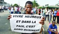 A subscriber who invested in agribusiness companies, takes part in a demonstration in Abidjan, Ivory Coast after justice froze the assets of some 28 companies suspected of a vast swindle. Attracted by juicy profits and investment returns, thousands of peo