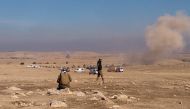 Smoke billows following a strike as Iraqi security forces hold a position near the village of al-Buseif, south of Mosul, during an offencive to retake the western side of the city from Islamic State (IS) group fighters on February 19, 2017. AFP / Marisol 