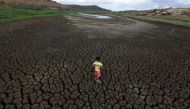 Natan Cabral, 5, stands on the cracked ground of the Boqueirao reservoir in the Metropolitan Region of Campina Grande, Paraiba state, Brazil, February 13, 2017. REUTERS/Ueslei Marcelino
