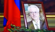Flowers are laid in front of a portrait of Russia's Ambassador to the United Nations Vitaly Churkin at the Foreign Ministry guest house in Moscow yesterday. 