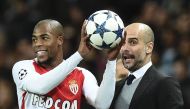 Manchester City's Spanish manager Pep Guardiola (R) reacts with Monaco's French defender Djibril Sidibe (L) during the UEFA Champions League Round of 16 first-leg football match between Manchester City and Monaco at the Etihad Stadium in Manchester, north