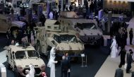 Visitors look at vehicles on display during the International Defence Exhibition and Conference (IDEX) in Abu Dhabi, United Arab Emirates February 19, 2017. REUTERS/Stringer
