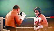 Qatari boxer Sheikh Fahad Al Thani (right) in action during a charity bout held at the Margarita Ramos Pavilion in Leon, Spain recently. Qatar's first ever professional boxer fought against current WBA super-lightweight champion from Scotland Ricky Burns 
