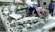 A Palestinian man from the Abu Ramouz family gathers his belongings outside his house that was demolished by Israeli army bulldozers in the Arab east Jerusalem neighbourhood of Beit Hanina, yesterday.