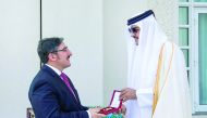 Emir H H Sheikh Tamim bin Hamad Al Thani conferring Decoration of Al Wajbah to the outgoing Turkish Ambassdor Ahmet Demirok, at the Emiri Diwan yesterday.