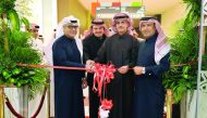 Sheikh Dr Khalid bin Thani bin Abdullah Al Thani (second right), Chairman and Managing Director of Qatar International Islamic Bank (QIIB), cutting a ribbon with other officials and guests during the opening of bank's new branch at the Mall of Qatar yeste