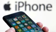 FILE PHOTO - An Apple iPhone 7 and the company logo are seen in this illustration picture taken in Bordeaux, France on February 1, 2017. REUTERS/Regis Duvignau/File Photo
