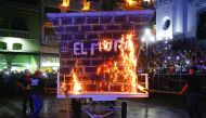 People burn a fake wall in a protest against US President Donald Trump during the inauguration of the carnival festival in Veracruz, Veracruz State, yesterday.