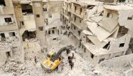 Civil defence members work at a site hit at dawn by an airstrike in the rebel-controlled town of Ariha in Idlib province, Syria, February 27, 2017. REUTERS/Ammar Abdullah
