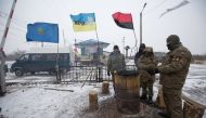 Activists warm themselves at a fire in a camp at Kryvyi Torets station as they take part in a rail blockade that has halted coal supplies in the village of Shcherbivka in Donetsk region, Ukraine, February 14, 2017.  REUTERS/Konstantin Chernichkin