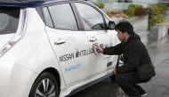 A technician cleans a modified Nissan Leaf, driverless car, between outings, during its first demonstration on public roads in Europe, in London, Britain February 27, 2017. REUTERS/Peter Nicholls