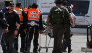 Israelis paramedics transport a Palestinian woman, who was shot and wounded by Israeli security forces upon failing to heed to repeated orders to halt, near the Qalandia checkpoint, between Jerusalem and the occupied West Bank, on February 27, 2017. AFP /