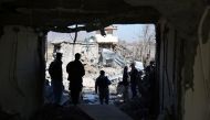 Afghan security forces investigate the wreckage of the district police headquarters in Kabul on March 2, 2017, a day after a suicide car bomb attack.  AFP / SHAH MARAI

