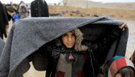Displaced Iraqis walk under rain while fleeing their homes, as Iraqi forces battle with Islamic State militants in western Mosul, Iraq, March 4, 2017. REUTERS/Zohra Bensemra
