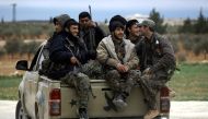 Manbij Military Council forces, part of the US-backed Syrian Democratic Forces (SDF), prepare to head to the frontlines on the outskirts of the northern Syrian town of Manbij on March 3, 2017.  AFP / DELIL SOULEIMAN

