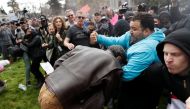 A demonstrator in support of U.S. President Donald Trump (L) scuffles with a counter-protester during a 