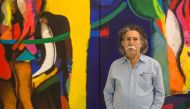 Iraqi artist Dia Al-Azzawi poses for a picture with his work at the Arab Museum of Modern Art in the Qatari capital Doha on October 19, 2016  (AFP Photo / Olya Morvan) 