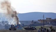 Iraqi government forces supported by fighters from the Abbas Brigade, which fight under the umbrella of the Shiite popular mobilisation units, advance in village of Badush some 15 kilometres northwest of Mosul during the ongoing battle to retake the city'