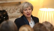 British Prime Minister Theresa May speaks to guests during an International Women's Day reception at 10 Downing Street in London on March 8, 2017. / AFP / POOL / Jonathan Brady
