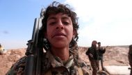  A young Syrian Democratic Forces(SDF) fighter poses for a picture with his weapon north of Raqqa city, Syria March 8, 2017. REUTERS/Rodi Said