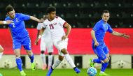 Qatar's  Akram Afif  (centre) vies for the ball possession with two Azerbaijani players during the friendly. Azerbaijan won 2-1 yesterday.
