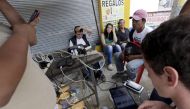 Residents use the internet via free wifi and charge their mobile phone batteries along a sidewalk in Pedernales, after an earthquake struck off Ecuador's Pacific coast, April 23, 2016. REUTERS/Henry Romero
