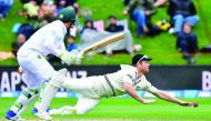 New Zealand's James Neesham (right) attempts to catch South Africa's Dean Elgar during day four of their first Test in Dunedin yesterday. 