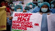 Members of the National Democratic Front of the Philippines (NDFP) hold a demonstration calling for peace negotiations and social economic reforms in Manila.PHOTO: AFP.