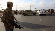 Forces loyal to Libya's Government of National Accord (GNA) man a checkpoint in the Hay al-Andalus neighbourhood of Tripoli on March 14, 2017, following clashes between rival armed groups.  AFP / MAHMUD TURKIA