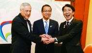 Chile's Foreign Minister Heraldo Munoz (L) shakes hands with Japan's State Cabinet Office Minister Takao Ochi (C) and Japan's Parliamentary Vice-Minister of Economy, Trade and Industry Toshinao Nakagawa during a meeting of the 