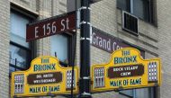 Signs honoring Hip-Hop pioneers Rock Steady Crew and US therapist Dr Ruth Westheimer hang from a lamp post as part of the Bronx Walk of Fame in the Bronx on March 7 2017 in New York. AFP / Don Emmert