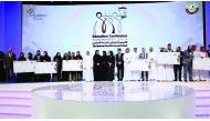 Minister of Education and Higher Education, H E Dr Mohammed Abdul Wahed Ali Al Hammadi, with winners of the National Scientific Researchers Week competition, during the closing ceremony of the Education Conference at QNCC yesterday.