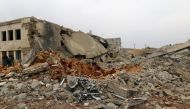 Civil defense members and people inspect a damaged mosque after an airstrike on the rebel-held village of al-Jina, Aleppo province in northwest Syria March 17, 2017. (REUTERS/Ammar Abdullah)